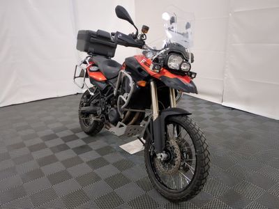 a motorcycle that is parked on a checkered floor