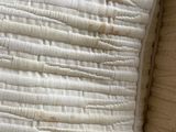 two pillows that are sitting next to each other on a bed