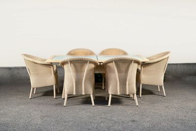 a table with four chairs around it on the concrete floor