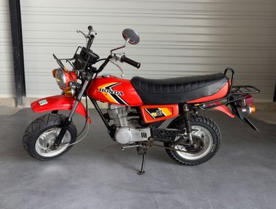 a red and black motorcycle parked in a garage
