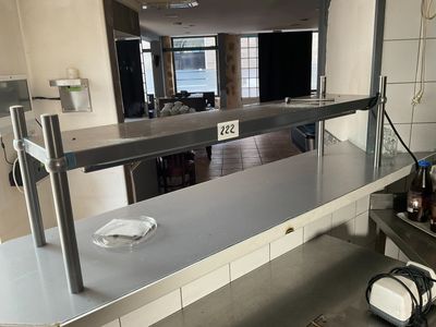 stainless steel counter top in a commercial kitchen with a microwave on it