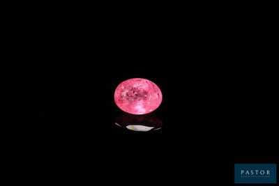 pink moon in the night sky with a reflection on the surface of the water