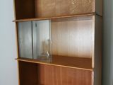 an image of a wooden bookcase with a glass door
