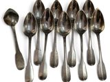 six spoons are lined up in a row on a white surface