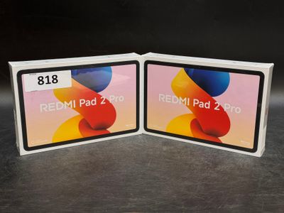 two redmi ipad 2g and ipad 3g are sitting side by side on a table