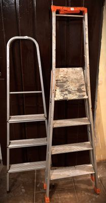 two ladders sitting next to each other on the floor