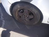 a white car that has a flat tire on it