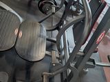 a gym room with a row of machines and other equipment