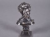 a silver figurine of an angel on a pedestal