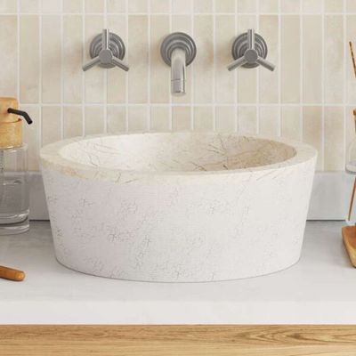 a white sink sitting on top of a counter next to a vase