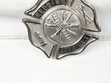 a firefighter badge on a white hat on a table