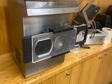 a microwave sitting on top of a wooden counter