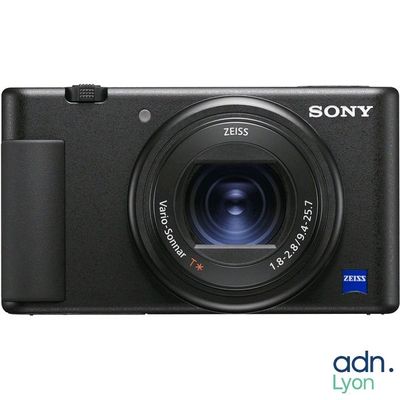 a black camera with a lens on a white background
