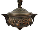 an antique bronze urn with a statue on top of it