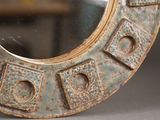 a round mirror that is sitting on a table