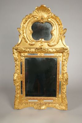 a gold frame with a mirror in it on a table