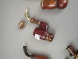 several different types of pipe holders on the wall
