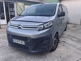 citroen van parked in front of a building in a parking lot