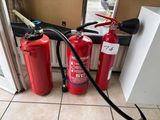 two fire extinguisors on the floor next to each other