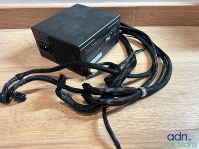 a close up of a computer power supply on a wooden table