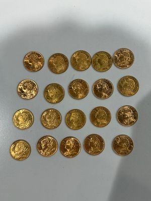 a lot of gold coins that are on the table
