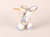 a small white vase with a blue and yellow design on it
