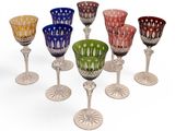 several different colored glass goblets sitting on top of each other