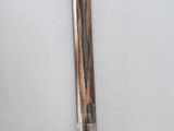 a silver spoon with a handle on a white surface