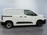 the white van is parked in a room with a gray floor