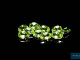 a close up of a group of green gems on a black background