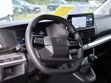 a car dashboard with a steering wheel and a dash board
