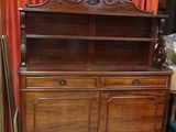 an old wooden china cabinet with a mirror on top of it