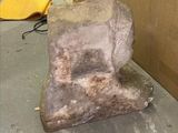 a large rock sitting on the floor next to a box