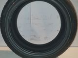 a close up of a tire on a white surface with a white wall in the background