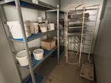a room with several shelves and a ladder in it