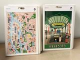 two boxes with maps on them sitting on a table
