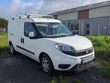 a white van parked in front of a building