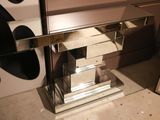 a mirrored table with a mirror top and a mirror shelf