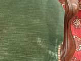 a green chair that is sitting on a rug