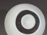 a white ball with a black center sitting on a table
