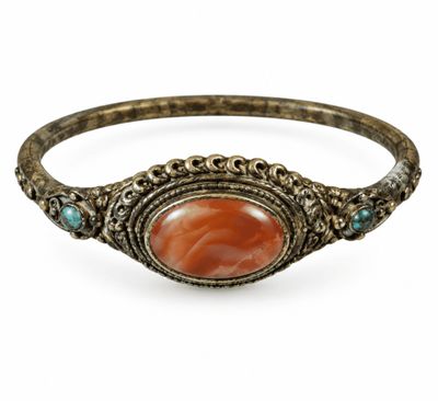 a close up of a bracelet with a stone in the center
