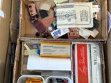 a cardboard box filled with assorted items on a table