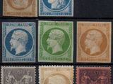 six different stamps of different colors and sizes on a black surface