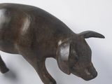 bronze statue of a pig on a white background