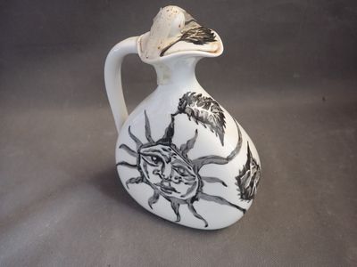 a white vase with a black and white design on it