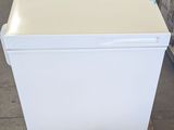 an image of a white refrigerator sitting on a pallet in a warehouse