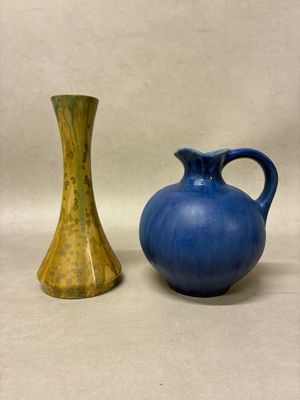 two vases sitting next to each other on a table