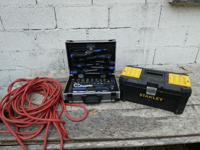 a tool box with tools on a table next to a tool box