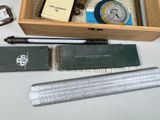 a wooden box with a clock, ruler, and other items on it