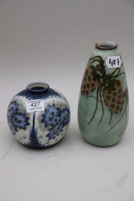 two vases sitting next to each other on a table